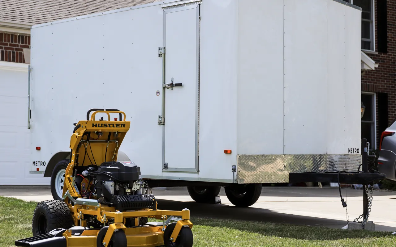 Landon's Lawn Care equipment trailer at a residential property