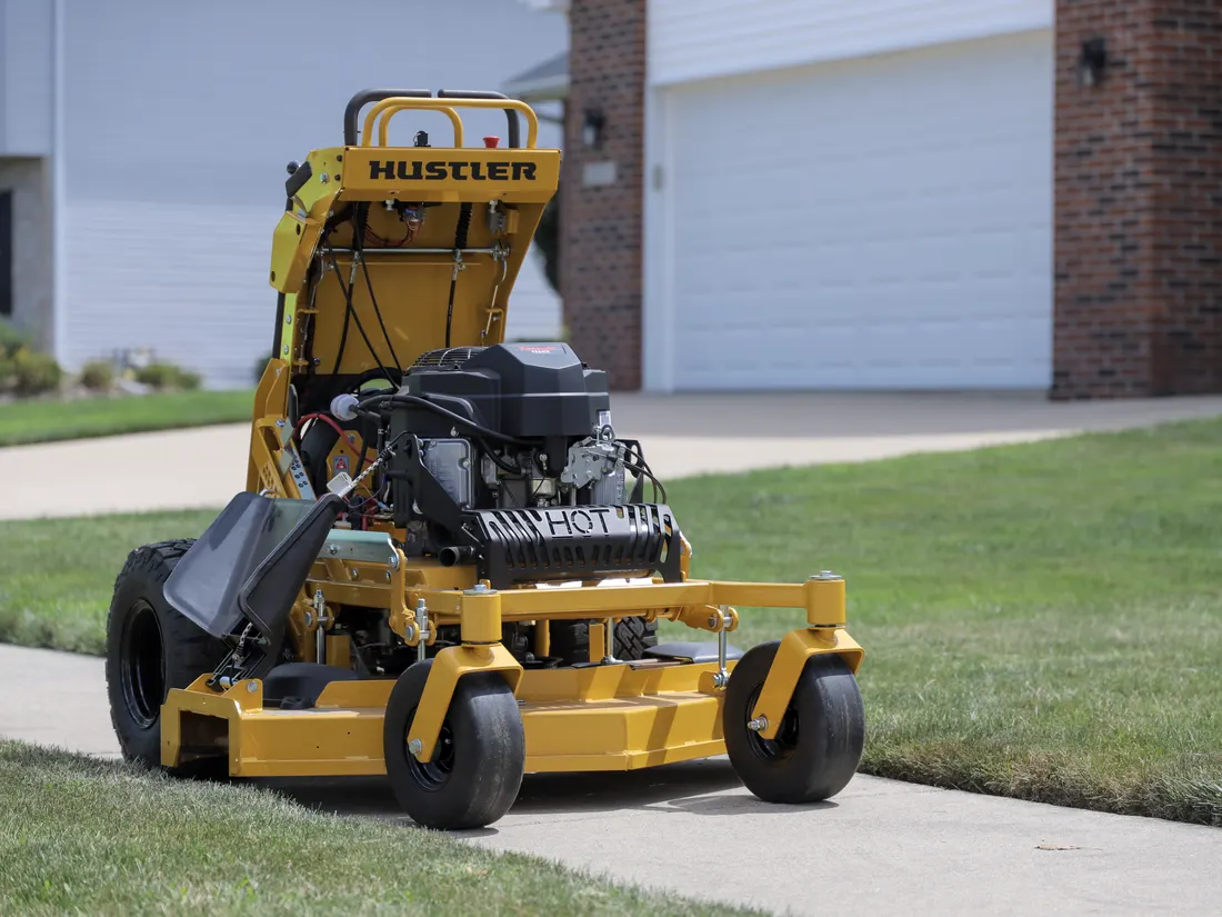 Landon's Lawn Care Hustler mower at a brick commercial property