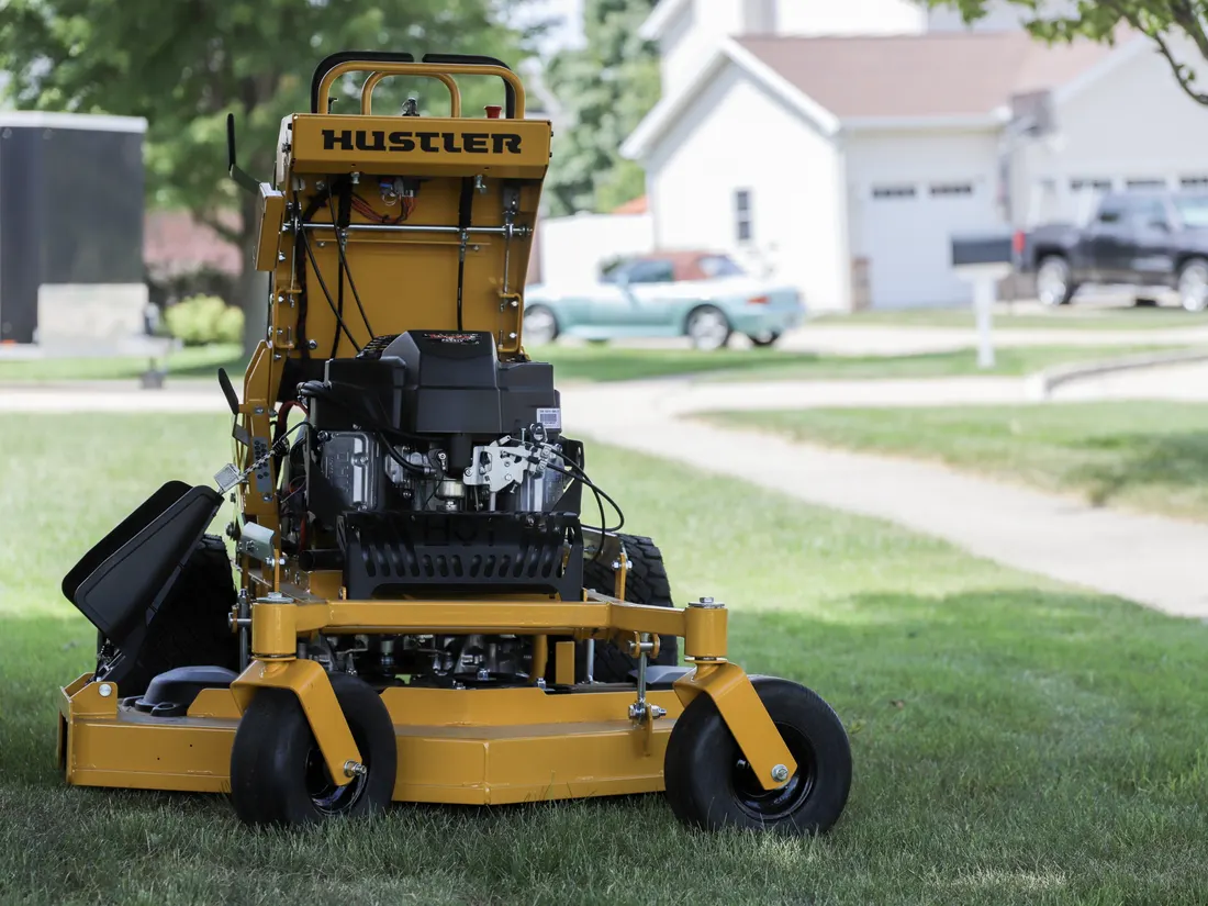 Landon's Lawn Care Hustler stand-on mower on a residential lawn